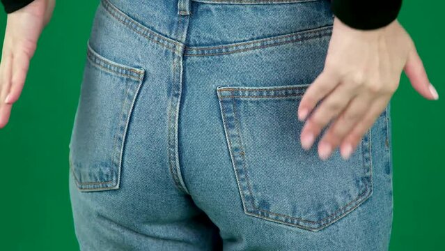 A tight female butt in burgundy jeans. female butt in jeans
