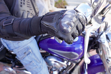 Motorcyclist in protection on a motorcycle close-up