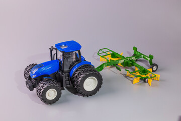 Close up view of standalone perspective of radio-controlled miniature farm tractor model equipped...