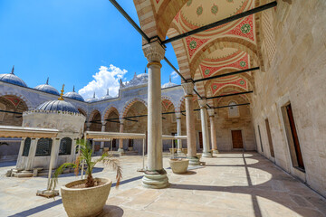 Istanbul's New Mosque courtyard, framed by a colonnaded with 24 small domes. An ornamental...