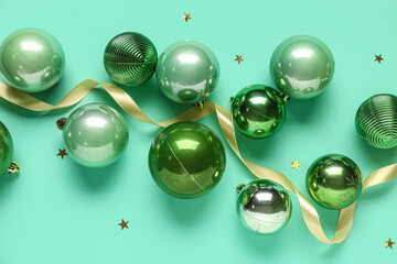 Christmas balls with ribbon on turquoise background
