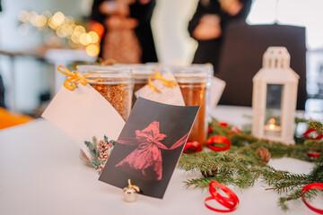 A card with a red bow on the Christmas table