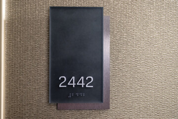 Hotel room number 2442 with braille.