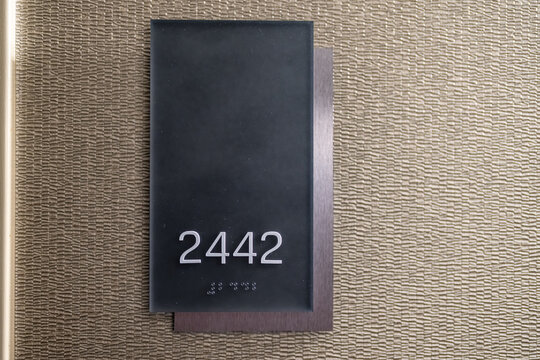Hotel room number 2442 with braille.