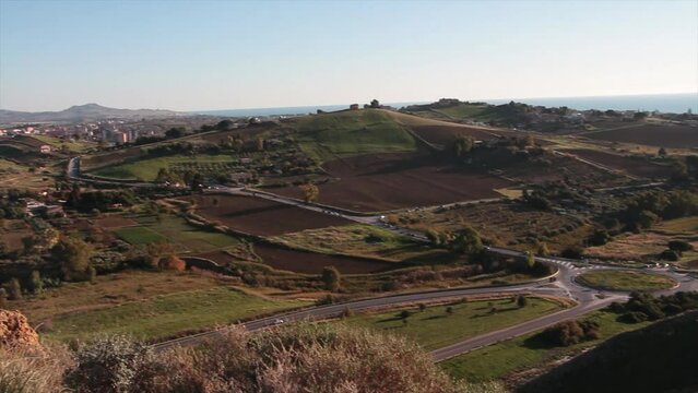 agrigento sicily italy roads streets outskirt outer perimeter hills dirt soil agriculture countryside trees shot from mountain high vantage point with pan left to right