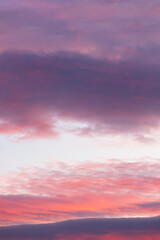 Sunset in the clouds. Colorful dramatic sky. Pastel graduated pink, purple and blue background. 