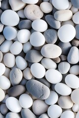 vertical pebbles texture background, closeup white smooth stones