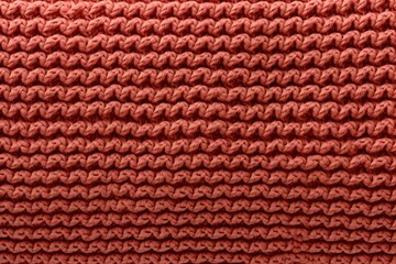 orange knitted wool fabric texture background, soft and cozy patterned surface