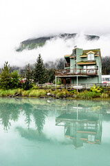Home Reflecting off Turquoise Waters of the Ocean in Seward, Alaska Surrounded by Kenai Fjords National Park