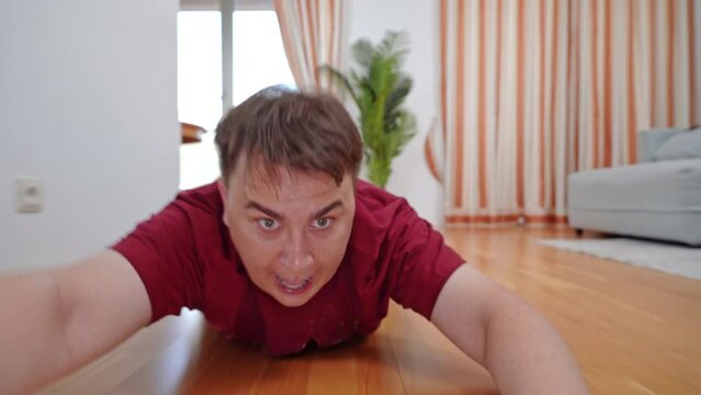 Man dragged across floor released left lying unconscious. Frightened man on floor loses consciousness after being dragged across parquet floor