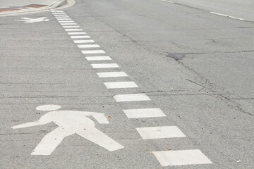 stencil outline illustration of person walking in white on cement pavement road street beside...
