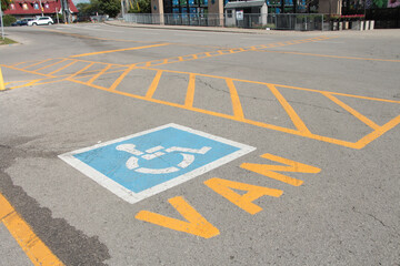 van handicap parking space with van written text below handicap symbol, road in background
