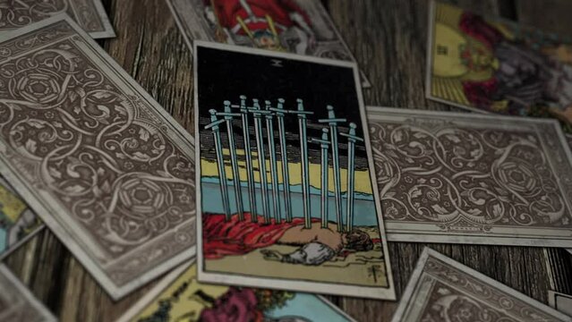 Berlin, Germany - July 15, 2015. Medieval future interpretation ritual on the Ten of Swords card describing fear. Old card ritual predicting fear of death. Card ritual forecasting fear of danger.