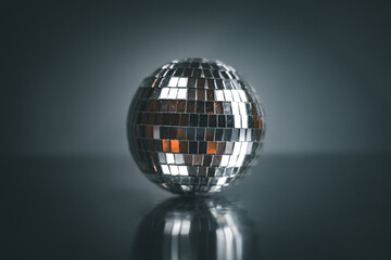 Silver disco ball with a dark background. 