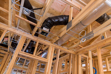 New construction home wooden framing with beams attached to roofing framework