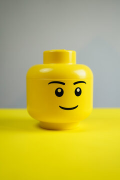 Yellow lego head on grey background, 15 September 2023, Poland.