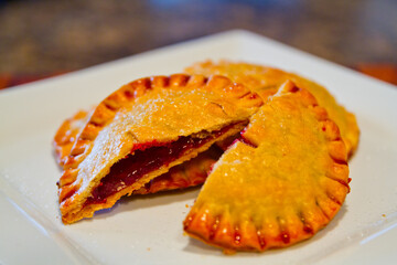Handmade Golden Crusted Fruit Hand Pie on White Plate Close-Up
