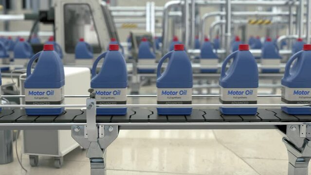 Industrial automated conveyor equipment transporting the produced motor oil. Industrial automated conveyor line sorting the blue jugs. Industrial automated conveyor machinery carrying the goods.