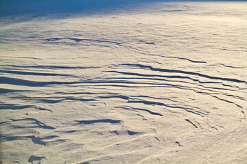 Winter's Artistry: Textured Snow Surface Illuminated at Sunrise in Fort Wayne