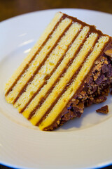 Close Up of Layered Chocolate Ganache Cake on White Plate