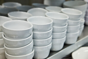 Neatly Stacked White Ceramic Bowls in Brightly Lit Kitchenware Store