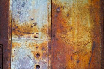 Rustic Industrial Decay - Weathered Metal Surface with Emblem in East St. Louis