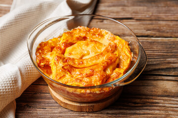 Casserole Roasted pumpkin with parmesan cheese baked in glass baking sheet. Vegetarian healthy food, autumn recipe