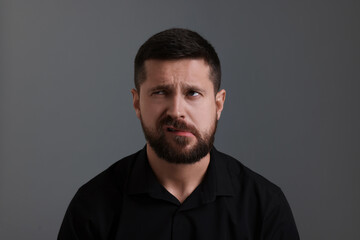 Obraz premium Personality concept. Emotional man on grey background