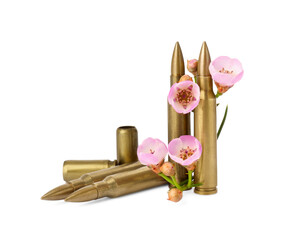 Bullets, cartridge cases and beautiful flowers isolated on white