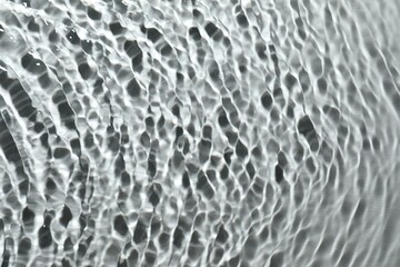 Rippled surface of clear water on light grey background, top view