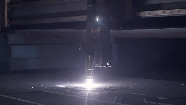 Industrial Machine With Laser Starts Cutting The Sheet Of Metal. Slow Motion. Modern Automated Equipment At Metal Production Factory. Manufacturing Process. Heavy Duty. Metallurgical Plant.