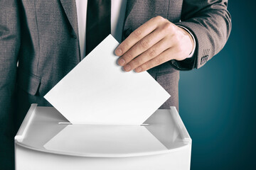 Man putting his vote into ballot box on gradient color background, closeup