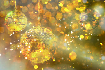 Shiny bright disco balls under golden lights, bokeh effect