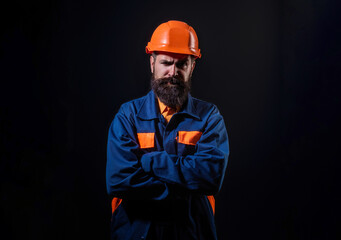 Builder worker in construction helmet. Builder foreman or repairman in builders uniform. Worker in studio. Construction manager, builder in helmet. Male builder engineer.