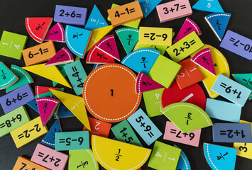 back to school background. colorful math fractions and notebook on the table. Mathematics and...