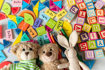 teddy bear, bunny close up with pencils, fractions, blocks on the table. activities for kids....