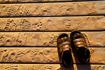 Golden Hour Footprints and Sandals on Michigan Boardwalk Top View