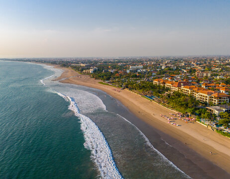 Aerial view of Seminyak beach coastline. The famous and luxury Kuta beach resort in southern Bali, Indonesia. Sunny day drone photo