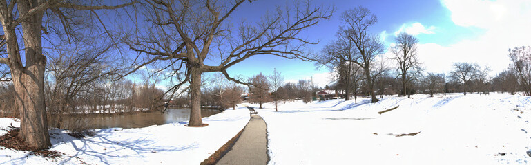 Panoramic Winter Solitude with Snowy Pathway, Leafless Trees, and Tranquil River