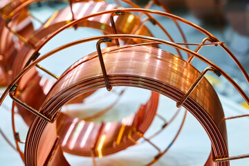 Shiny brass welding wire coil on table in supplies store