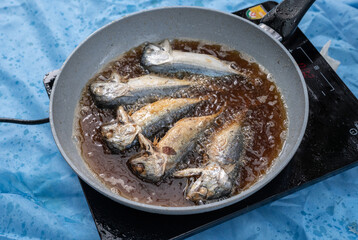 Thai Mackerel fish frying in hot oil. Mackerels, being oily fish, have high amounts of omega-3s.