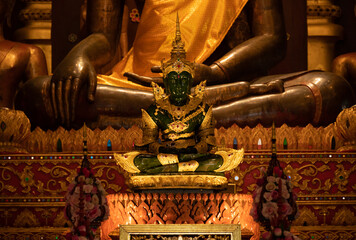An emerald Buddha statue with golden crown and costume decoration situated in Wat Phra Kaew temple...