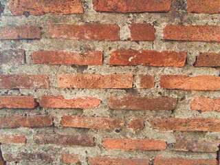 The red brick walls are brittle with age