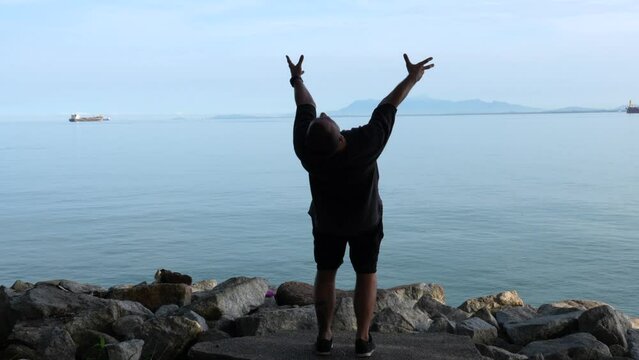 Male dancer dance with the sea view.