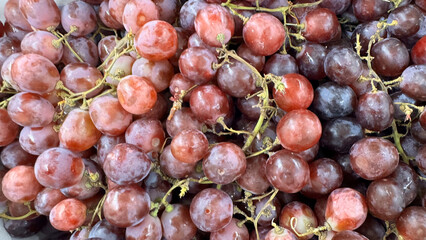 Close up of raw organic sweet red grapes background, wine grapes texture, Healthy fruits Red wine grapes background, top view