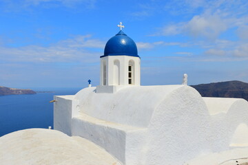 SANTORINI,GREECE-June 20 2023: Oia village, the most picturesque village on Santorini island, a famous touristic resort in the Cyclades islands, Aegean sea, Greece, Europe. This was on a hot sunny day