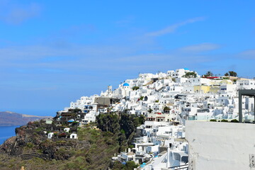 Fototapeta na wymiar SANTORINI,GREECE-June 20 2023: Oia village, the most picturesque village on Santorini island, a famous touristic resort in the Cyclades islands, Aegean sea, Greece, Europe. This was on a hot sunny day