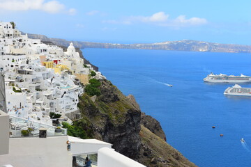 Fototapeta na wymiar June 18, 2023: Ferry passing the calderea of Fira, Santorini, Cyclades, Greek Islands, Greece, Europe. This was on a sunny day with a clear horizon in this stunning and picture perfect Greek Island.