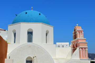 SANTORINI,GREECE-June 20 2023: Oia village, the most picturesque village on Santorini island, a famous touristic resort in the Cyclades islands, Aegean sea, Greece, Europe. This was on a hot sunny day