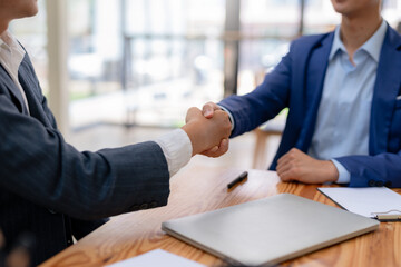 Business success. Business people handshake agreement confirmed in the investment business.